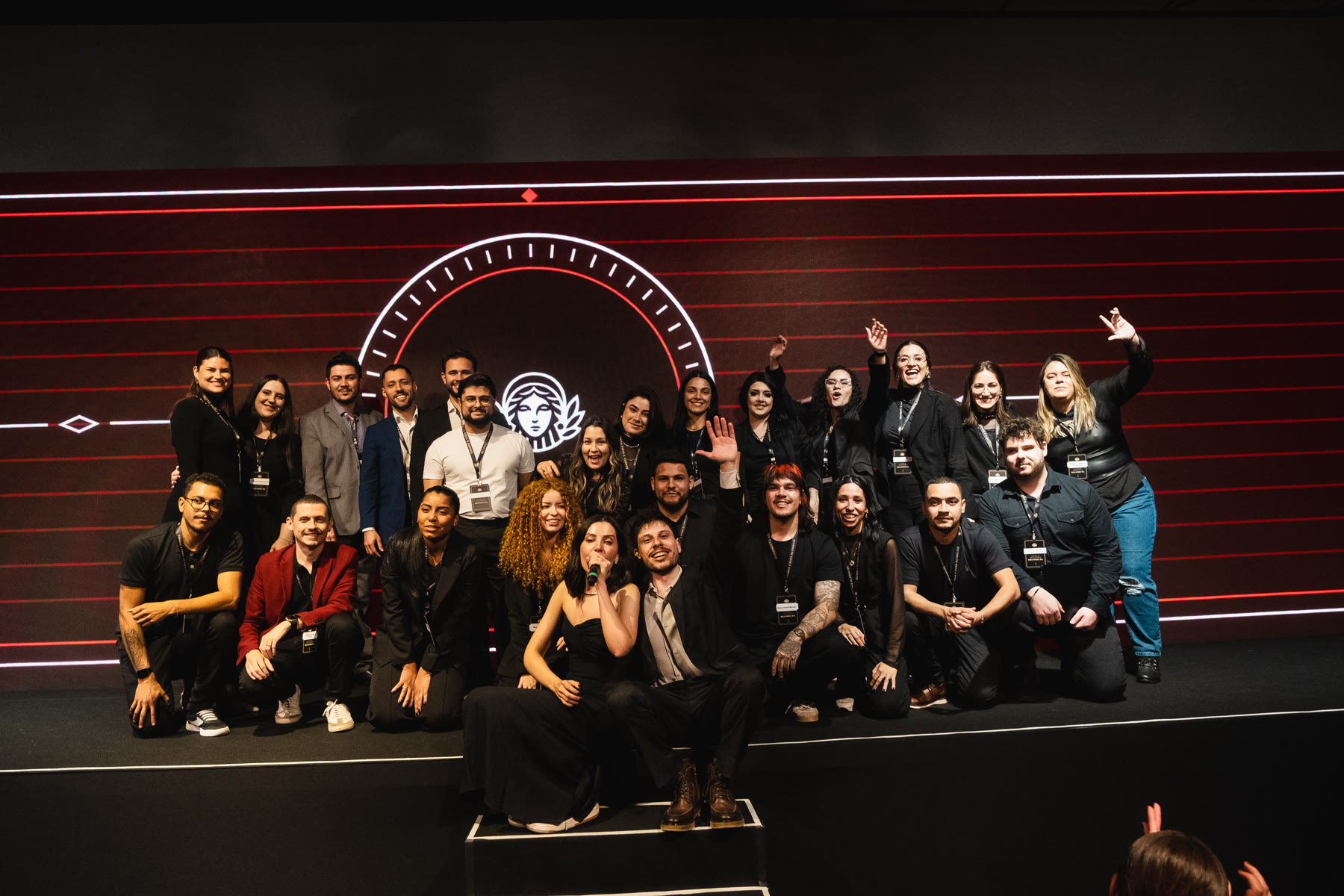 O time da Reconecta posado no palco, no encerramento do evento de agosto de 2026